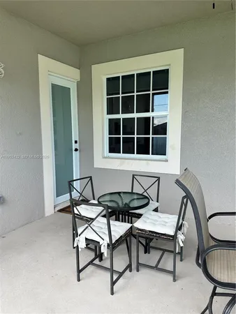a dining room with furniture and a window