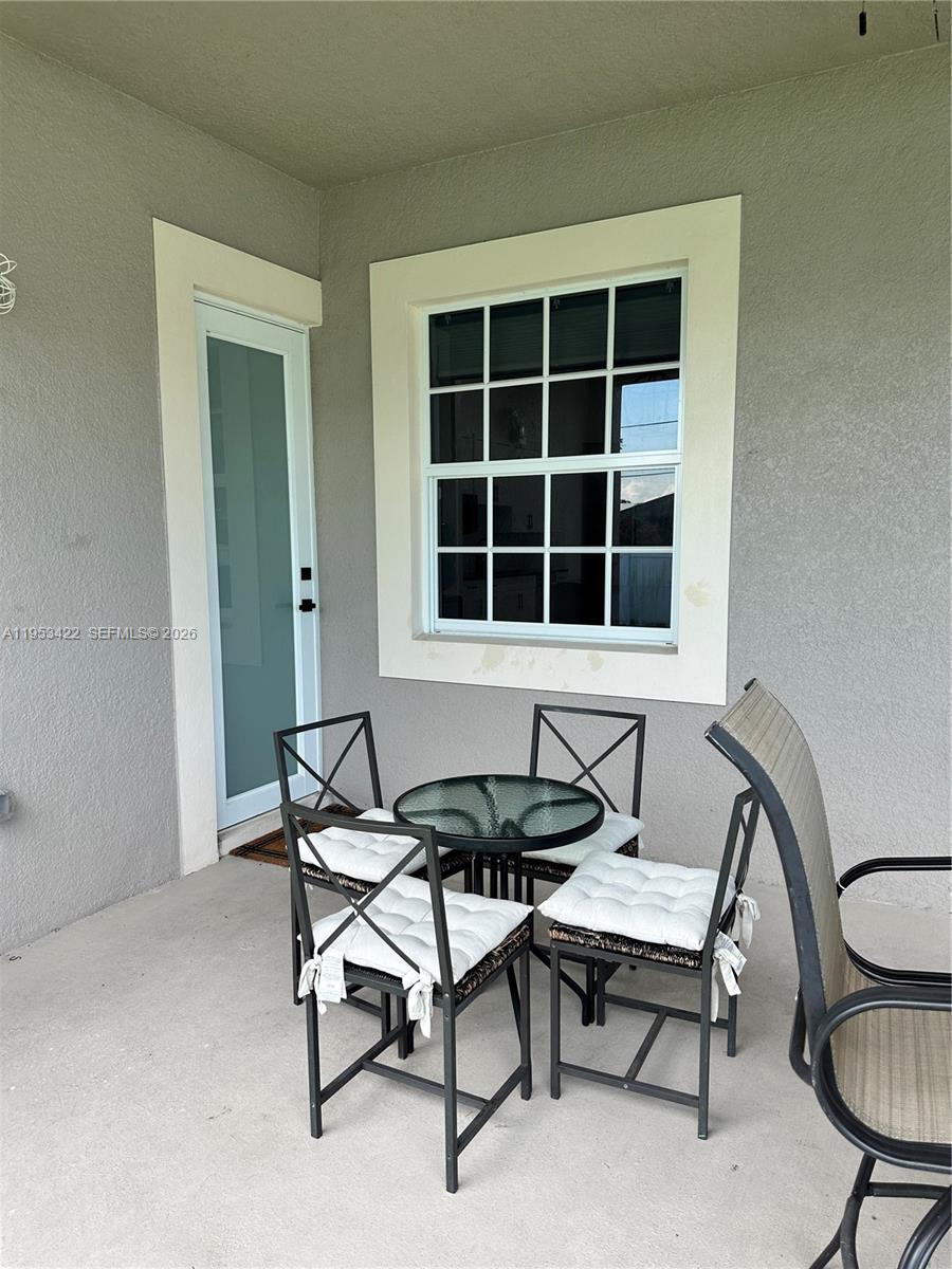 1222 Southwest Herald Road Port St. Lucie, FL 34953 - Photo 16 of 25 a dining room with furniture and a window
