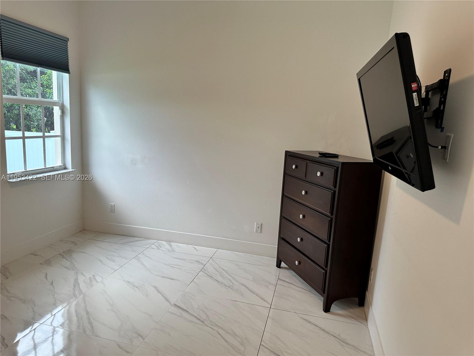 1222 Southwest Herald Road Port St. Lucie, FL 34953 - Photo 19 of 25 an empty room with windows