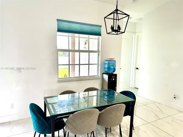 a view of a dining room with furniture window and outside view