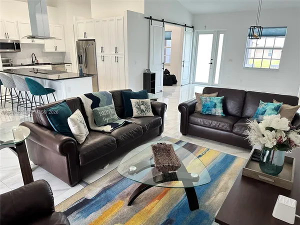 a living room with furniture wooden floor and a table