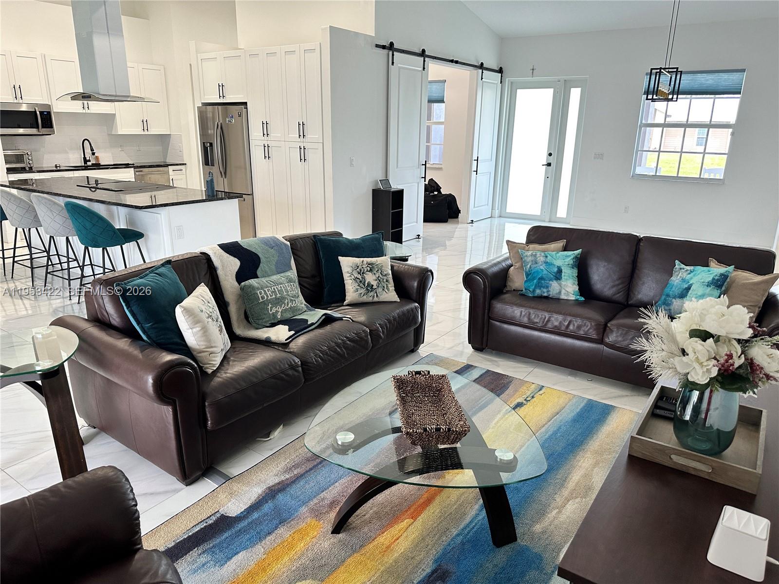 1222 Southwest Herald Road Port St. Lucie, FL 34953 - Photo 23 of 25 a living room with furniture wooden floor and a table