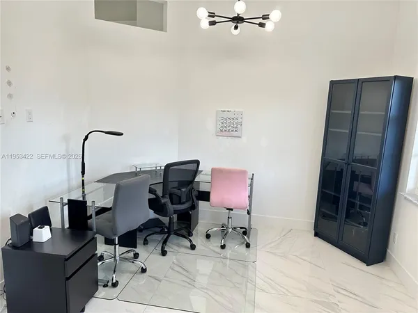 a work room with furniture and wooden floor