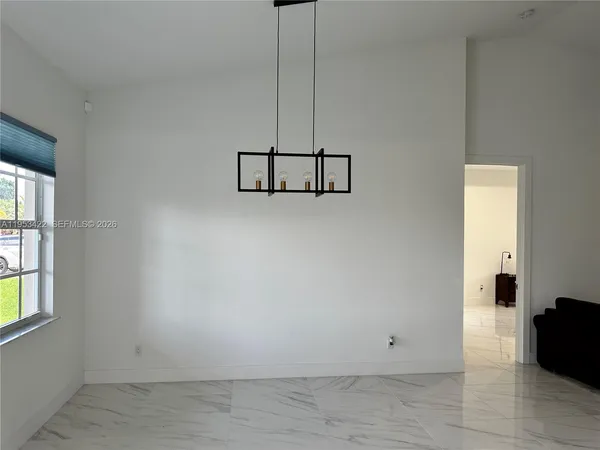 a view of a room with wooden floor and windows