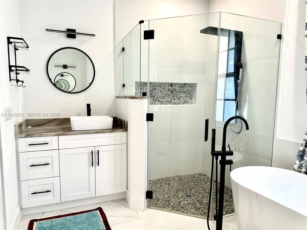 a bathroom with a sink a toilet and a mirror