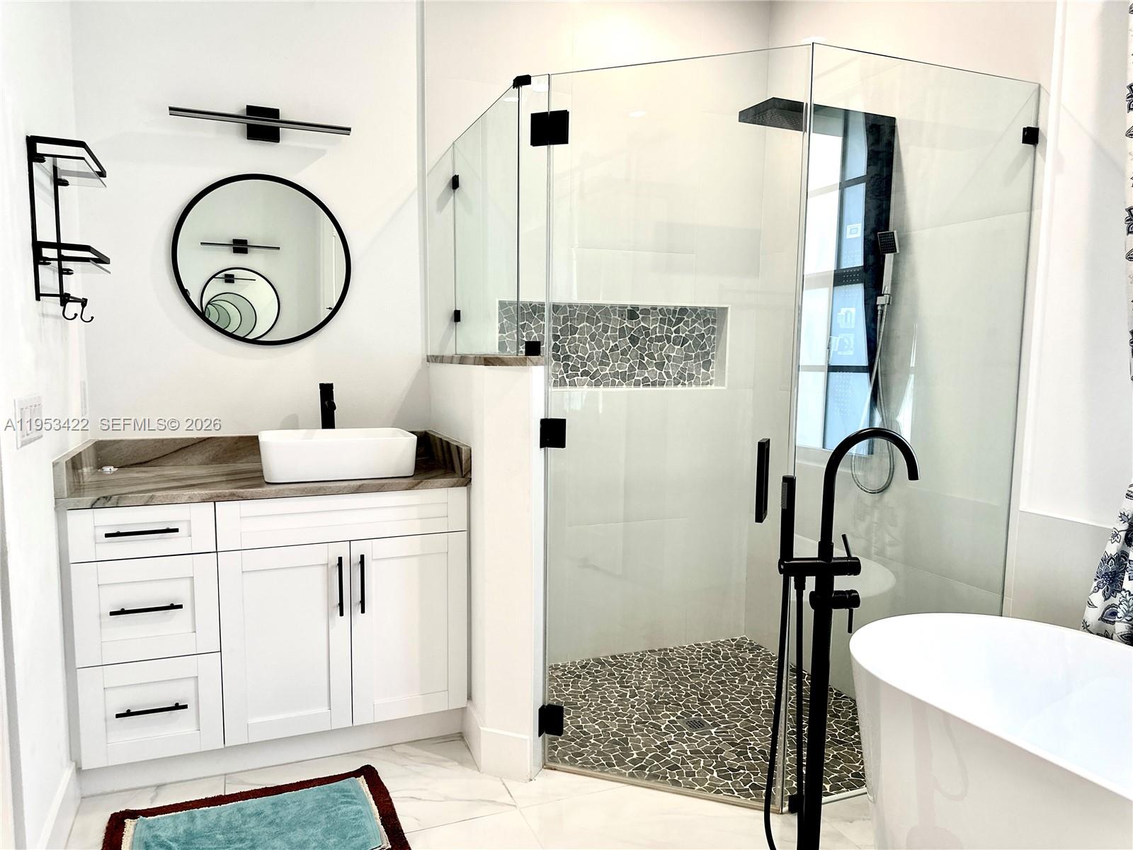 1222 Southwest Herald Road Port St. Lucie, FL 34953 - Photo 6 of 25 a bathroom with a sink a toilet and a mirror