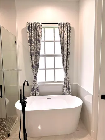 a white bath tub sitting next to a window
