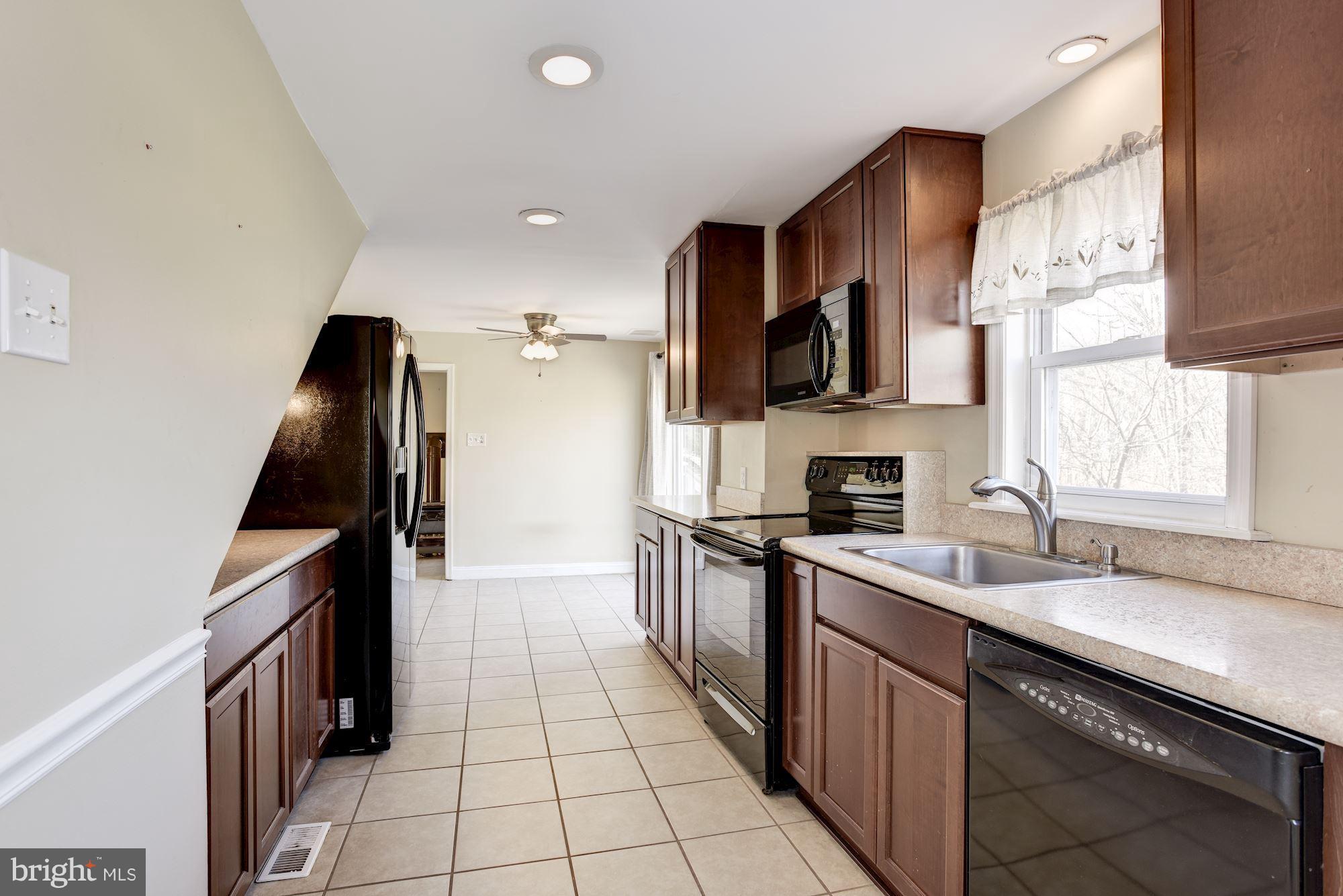 11914 Legore Bridge Road Keymar, MD 21757 - Photo 15 of 30 a kitchen with a sink stove and cabinets