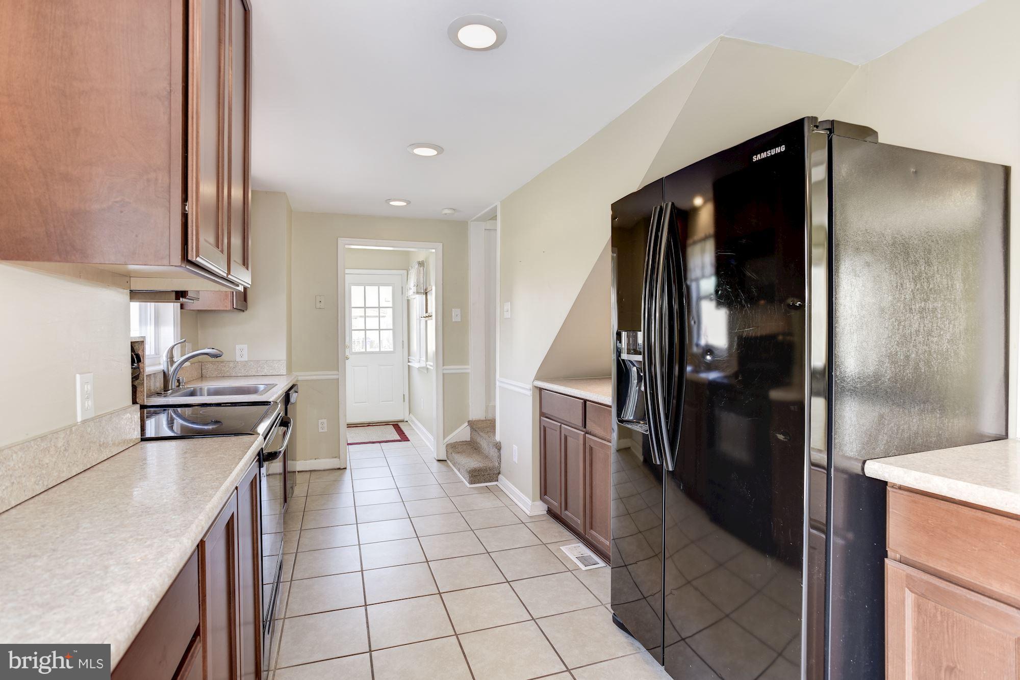 11914 Legore Bridge Road Keymar, MD 21757 - Photo 16 of 30 a kitchen with stainless steel appliances granite countertop a refrigerator and a stove top oven