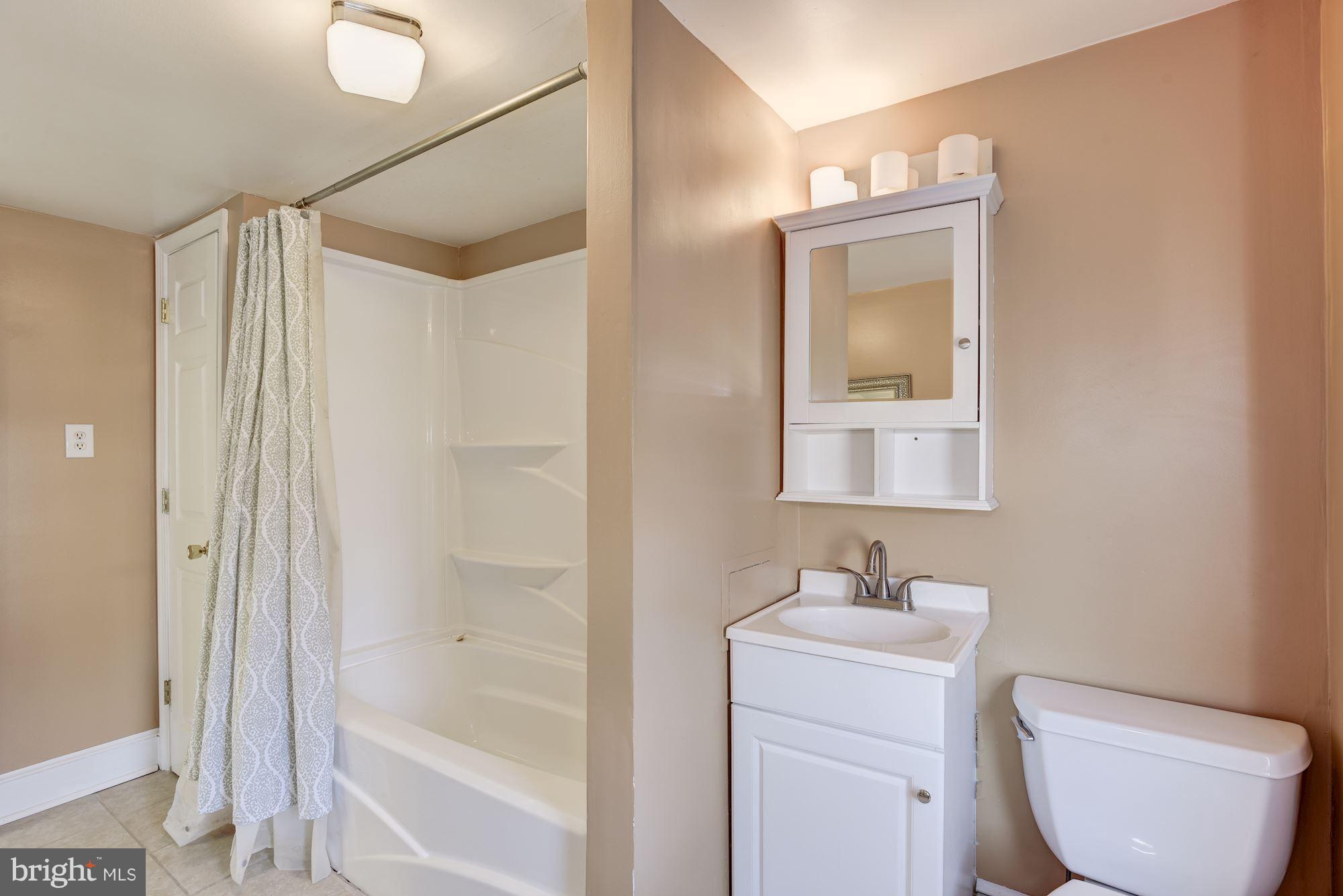 11914 Legore Bridge Road Keymar, MD 21757 - Photo 22 of 30 a bathroom with a granite countertop sink toilet and shower