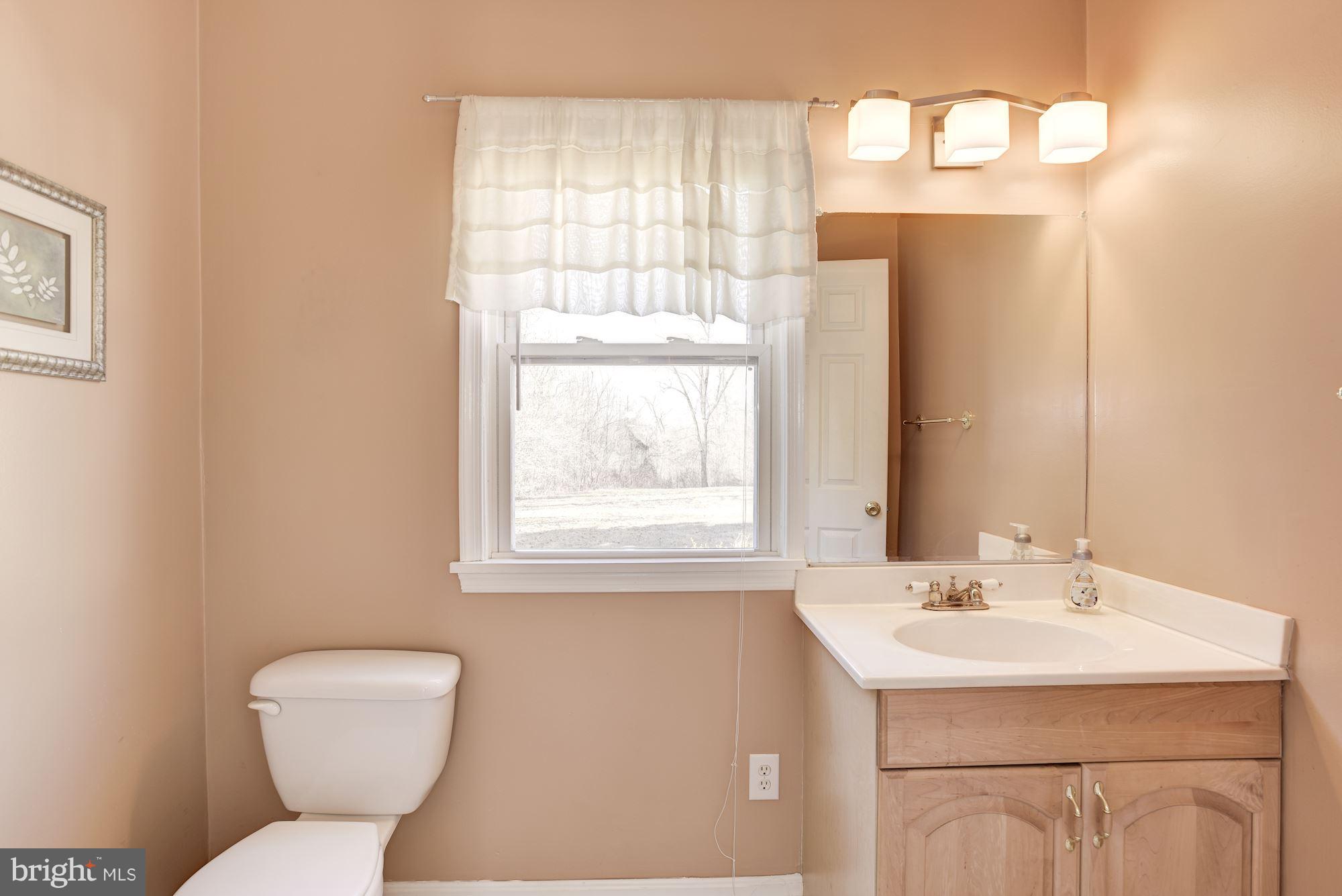 11914 Legore Bridge Road Keymar, MD 21757 - Photo 10 of 30 a bathroom with a sink a toilet and a mirror