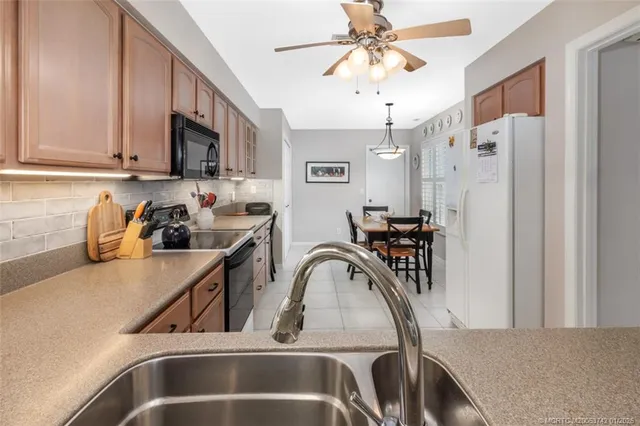 a view of a white house with a yard and sitting area