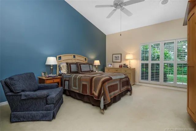 an aerial view of lake residential house with outdoor space and trees around