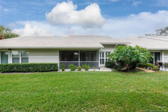 a view of a chairs and table in patio with a lake view