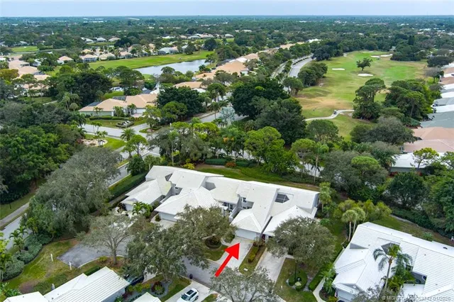 an aerial view of a house with outdoor space and lake view