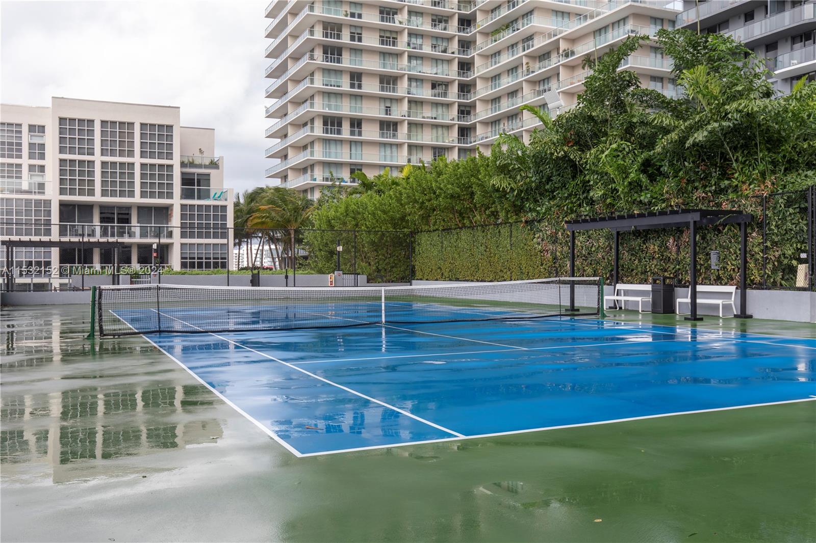 121 Northeast 34th Street, Unit L206 Miami, FL 33137 - Photo 15 of 18 a view of a swimming pool with a lounge chairs