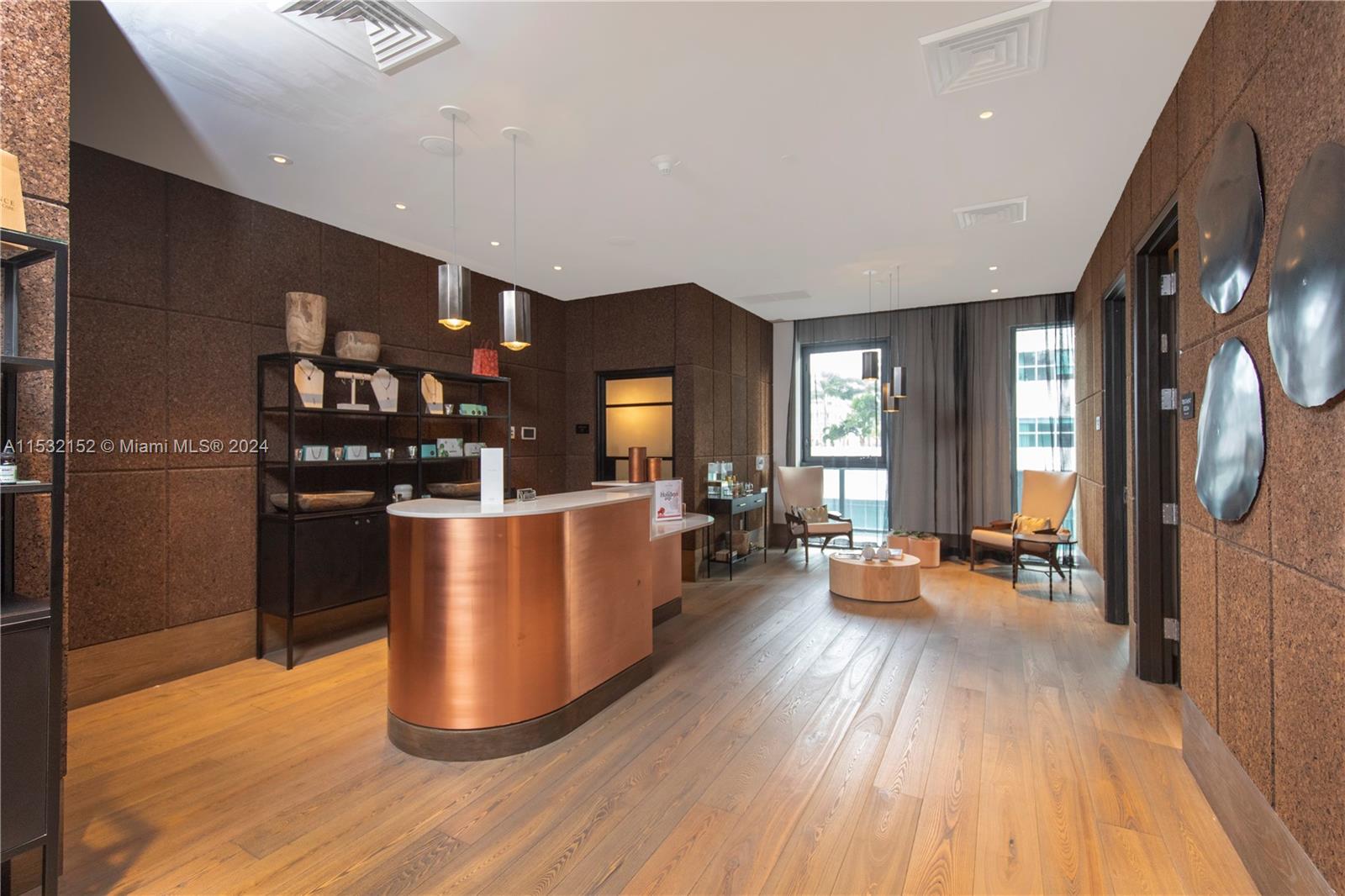 121 Northeast 34th Street, Unit L206 Miami, FL 33137 - Photo 17 of 18 a living room with couches and kitchen view with wooden floor