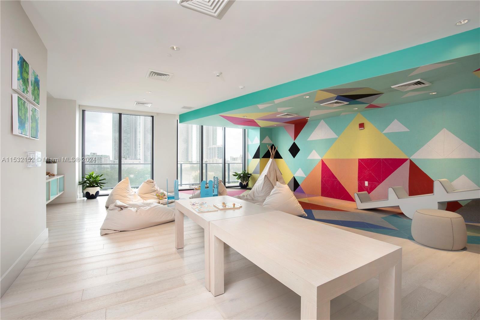 121 Northeast 34th Street, Unit L206 Miami, FL 33137 - Photo 9 of 18 a room with musical instruments and wooden floor