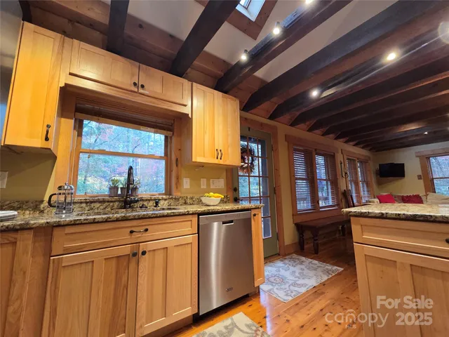 a kitchen with stainless steel appliances granite countertop a refrigerator and a stove