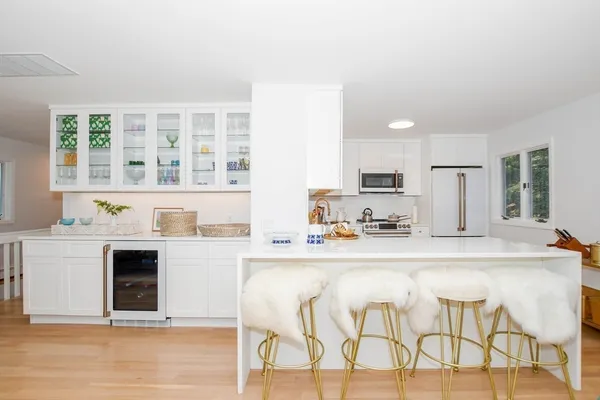 a kitchen with stainless steel appliances a refrigerator and cabinets