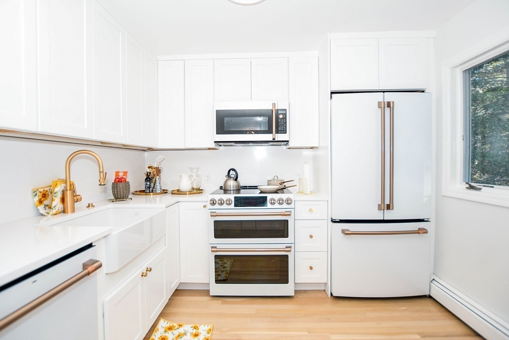 44 Register Road Marion, MA 02738 - Photo 13 of 38 a kitchen with stainless steel appliances granite countertop a refrigerator and a stove top oven