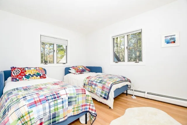 a bedroom with two beds and a window