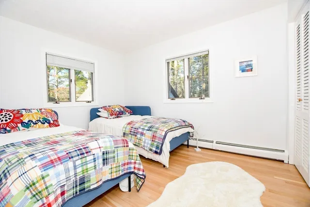 a bedroom with two beds and a baby crib