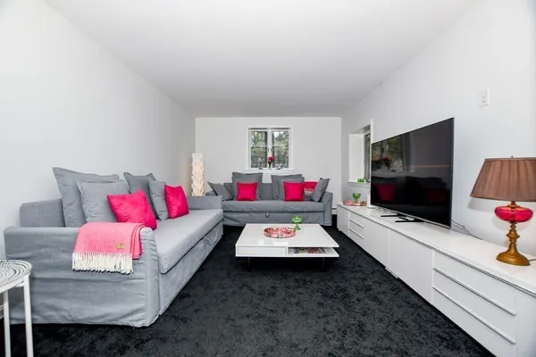 a living room with furniture and a flat screen tv