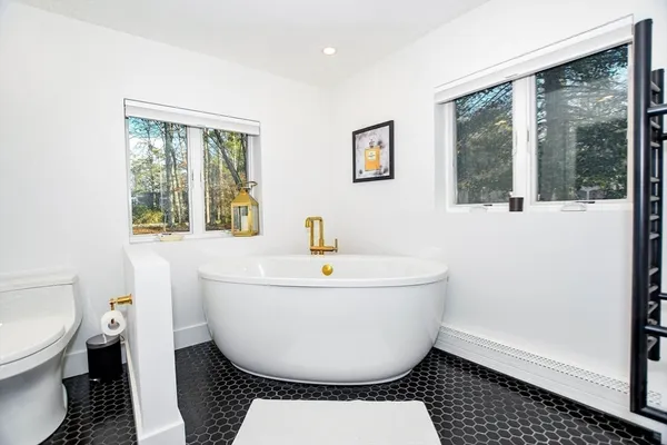 a bathroom with a toilet a sink and a mirror