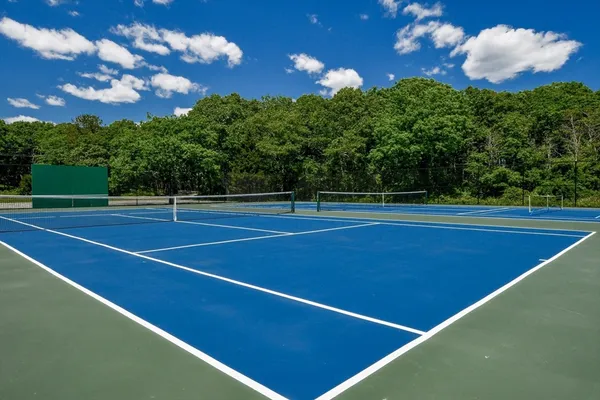 a sign board with a building in the background