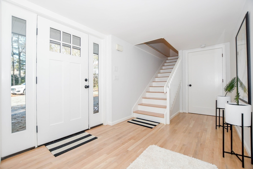 44 Register Road Marion, MA 02738 - Photo 5 of 38 a view of an empty room with wooden floor and stairs