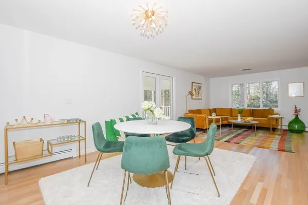 a view of a dining room with furniture and a chandelier