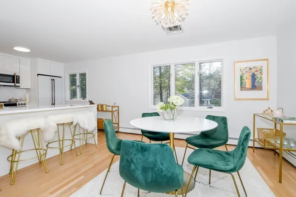 a kitchen with stainless steel appliances granite countertop a stove a sink dishwasher and a refrigerator with wooden floor