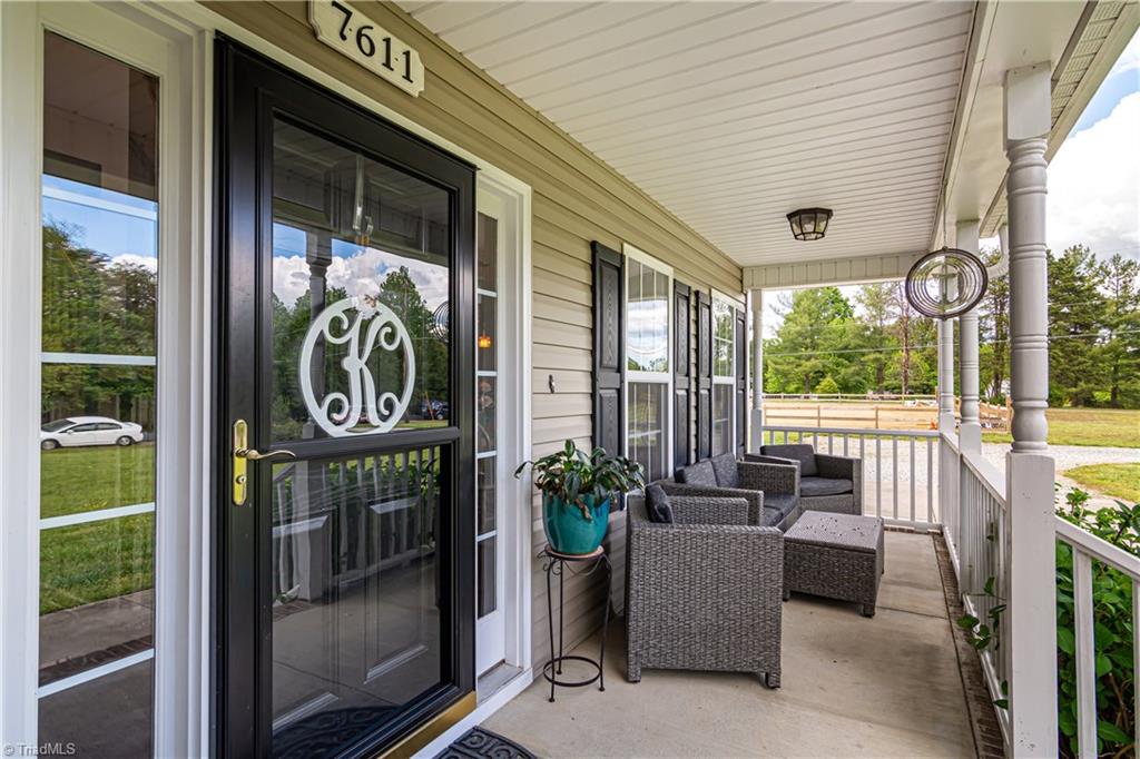 7611 Strawberry Road Summerfield, NC 27358 - Photo 2 of 22 Peaceful covered front porch perfect for relaxing with a nice cup of coffee!