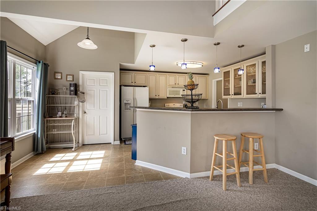 7611 Strawberry Road Summerfield, NC 27358 - Photo 7 of 22 The eat in bar has room for everyone!