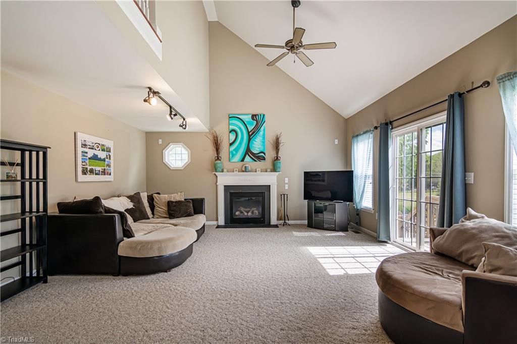 7611 Strawberry Road Summerfield, NC 27358 - Photo 8 of 22 The spacious living room features a gas fireplace.