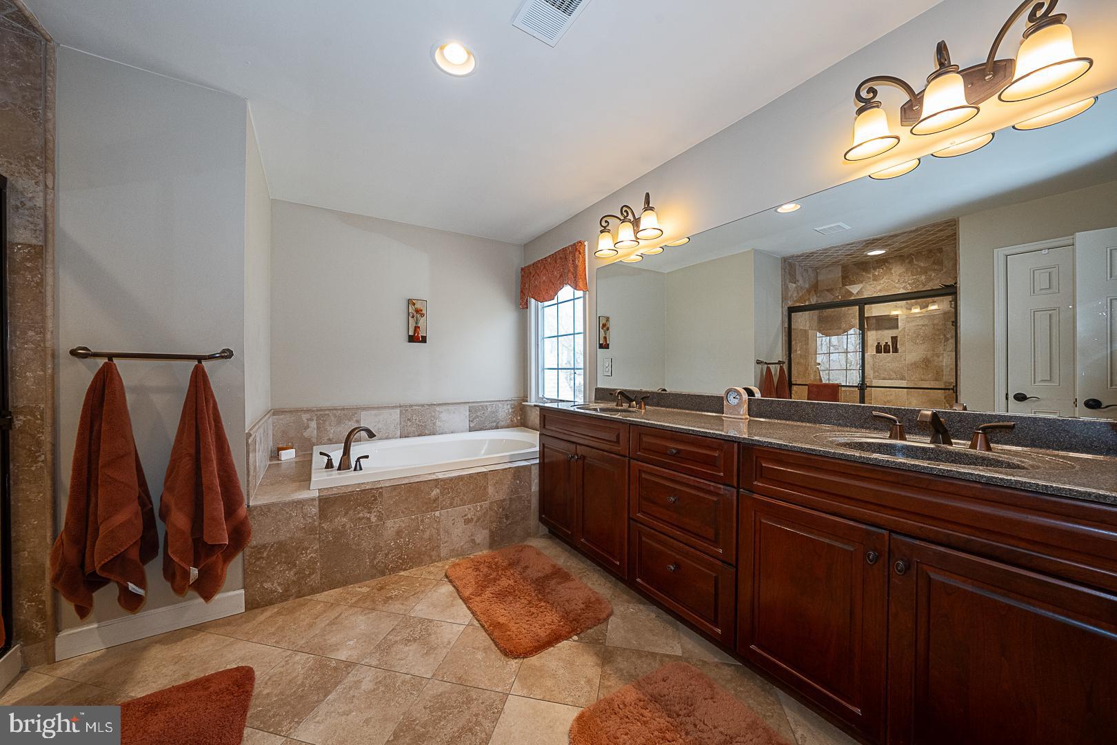 1545 Morstein Road Malvern, PA 19355 - Photo 20 of 41 a bathroom with a tub sink and mirror