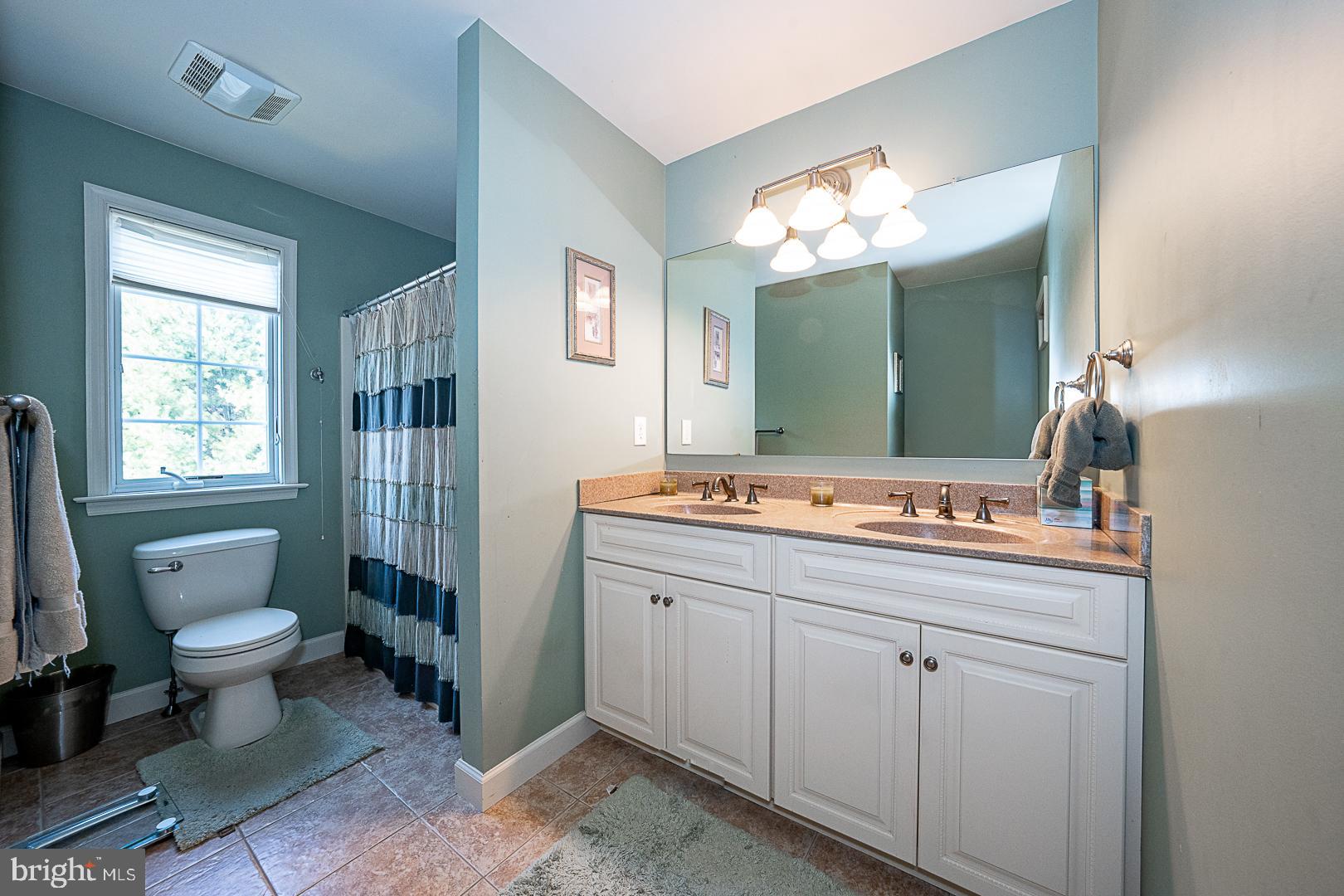 1545 Morstein Road Malvern, PA 19355 - Photo 27 of 41 a bathroom with a toilet sink and mirror