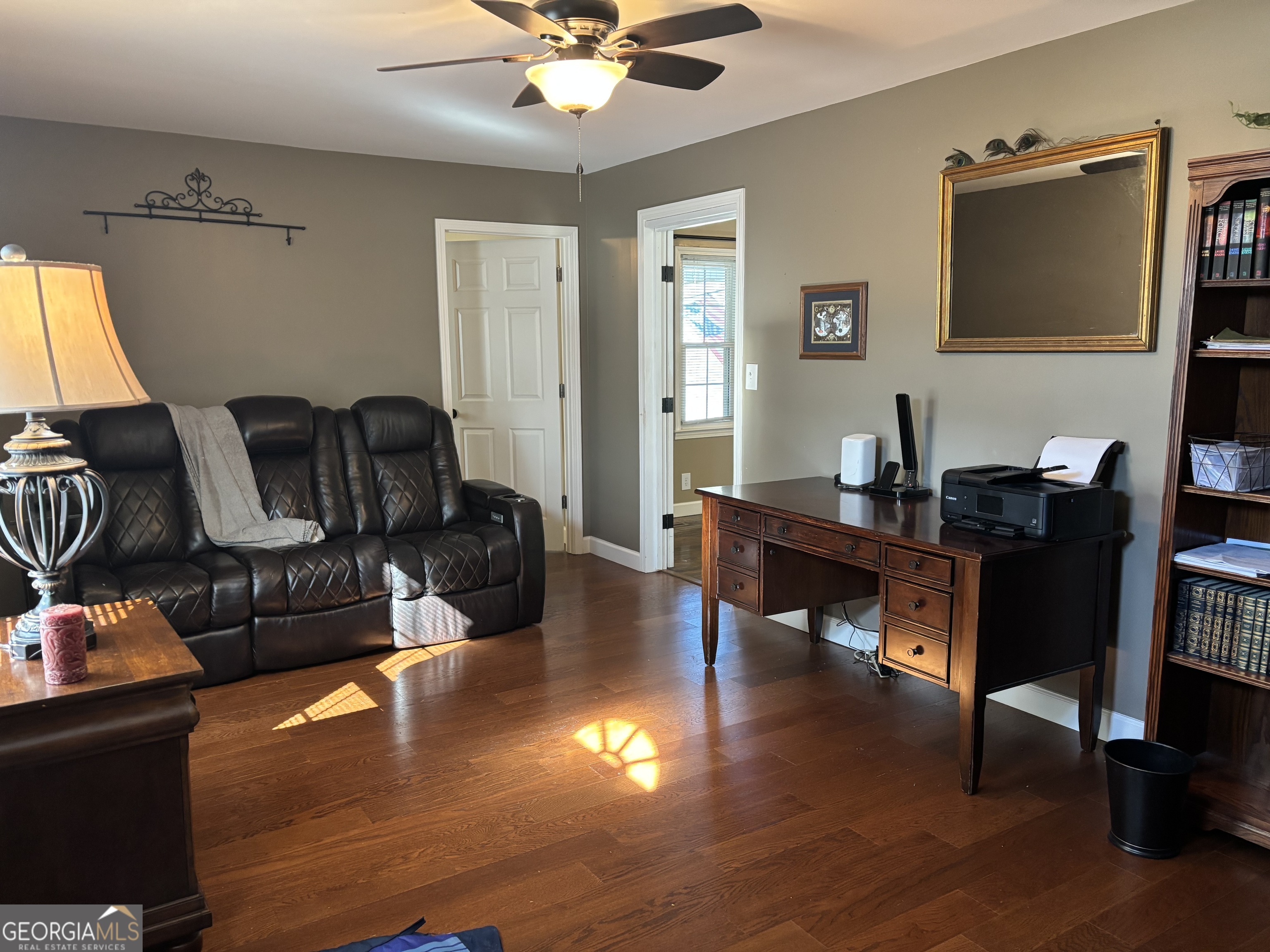 1517 Cave Spring Road Southwest Rome, GA 30161 - Photo 14 of 25 a living room with furniture a dining table and a flat screen tv with wooden floor