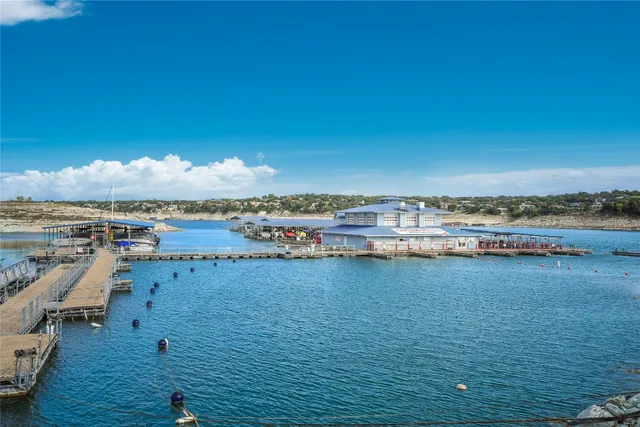 a living room with lots of furniture and a kitchen view