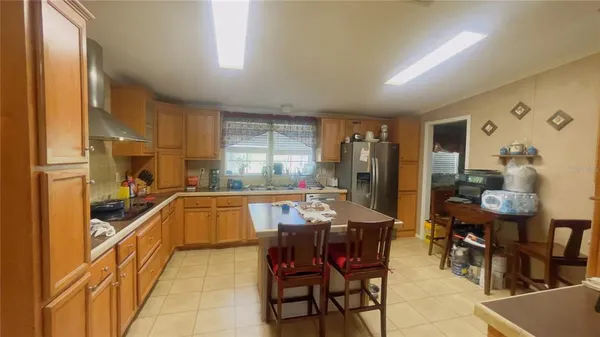a kitchen with granite countertop a sink and chairs