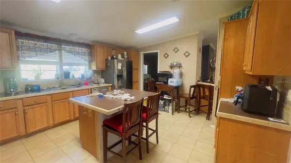 a kitchen with a sink and chairs