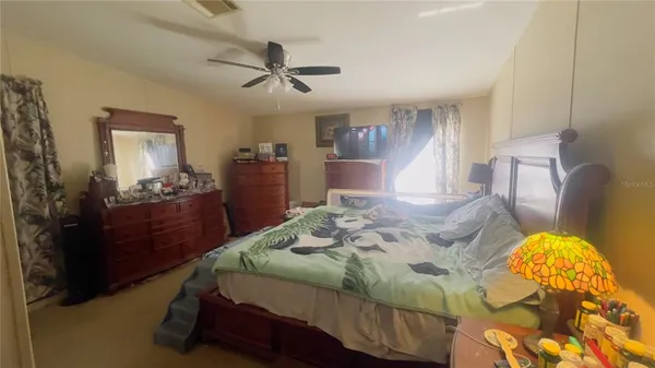 a bedroom with a bed and dresser with mirror