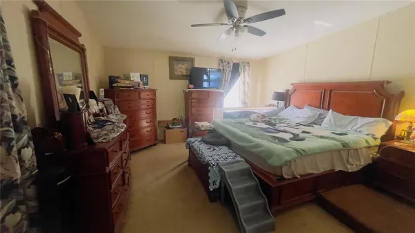 a bedroom with a bed and a mirror