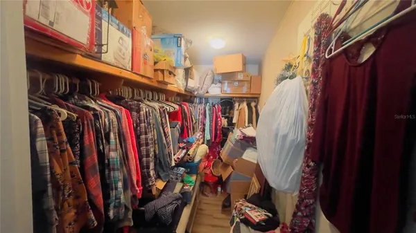 a view of walk in closet with clothes