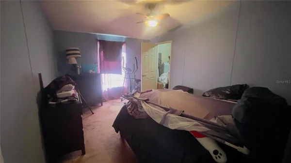 a bed sitting in a bedroom next to a window