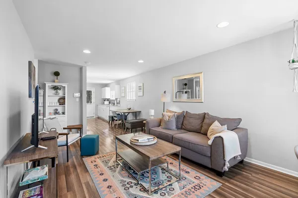 a living room with furniture a rug and a table