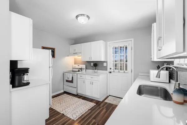 a kitchen with a sink stove and refrigerator
