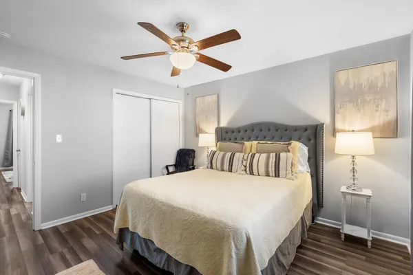 a bedroom with a large bed and a chandelier