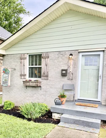 a view of a patio with table and chairs and potted plants